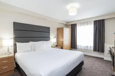 a hotel room with a large bed and a window at Sandman Hotel Grande Prairie in Grande Prairie