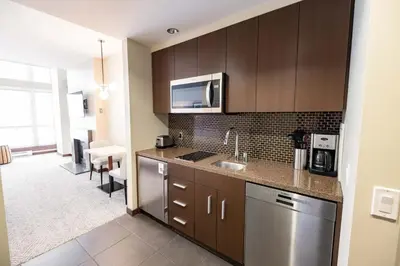 a kitchen with a sink and a microwave at Sutton Place Hotel Revelstoke Mountain Resort in Revelstoke