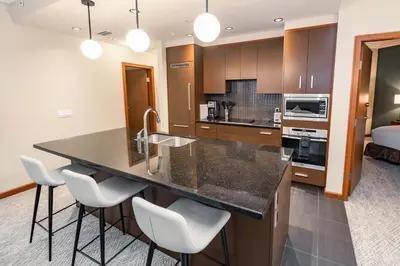 a kitchen with a large island in a room at Sutton Place Hotel Revelstoke Mountain Resort in Revelstoke