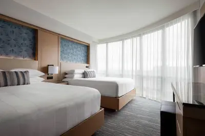a hotel room with two beds and a window at Vancouver Airport Marriott Hotel in Richmond