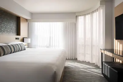 a hotel room with a large bed and a large window at Vancouver Airport Marriott Hotel in Richmond