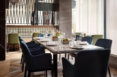 a dining room with a large table and chairs at Vancouver Airport Marriott Hotel in Richmond