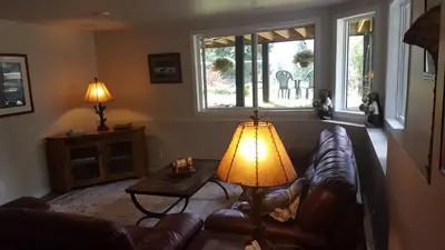 a living room with a couch and a lamp at Deer Ridge B&B in Golden