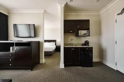 a hotel room with a sink and a bed at Hotel Rialto in Victoria