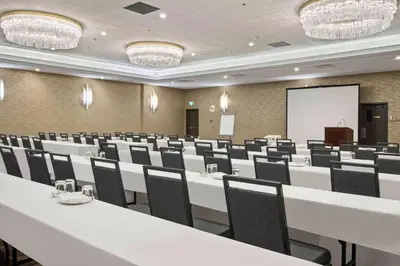 a conference room with white tables and chairs at Best Western Premier Calgary Plaza Hotel & Conference Centre in Calgary