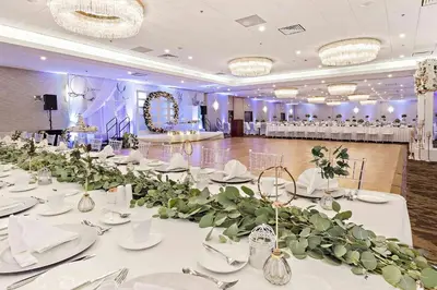 a large banquet hall with white tables and flowers at Best Western Premier Calgary Plaza Hotel & Conference Centre in Calgary