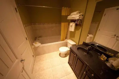 a bathroom with a sink and a toilet and a shower at Days Inn by Wyndham Surrey in Surrey