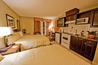 a hotel room with two beds and a kitchen at Days Inn by Wyndham Surrey in Surrey