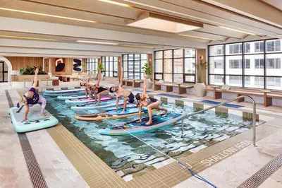 a group of people on surfboards in a pool at The Westin Calgary in Calgary