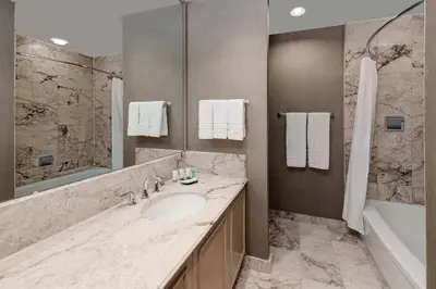 a bathroom with a sink and a shower and a tub at The Westin Calgary in Calgary