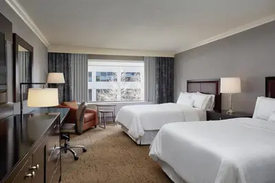 a hotel room with two beds and a window at The Westin Calgary in Calgary