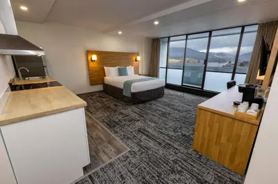 a hotel room with a bed and a large window at Highliner Hotel in Prince Rupert