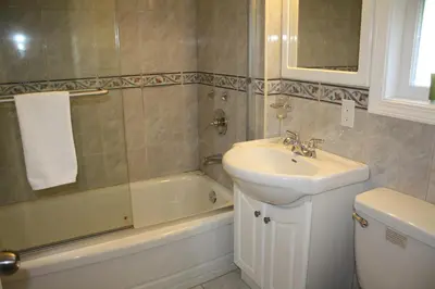 a bathroom with a sink and a toilet and a bath tub at The Classic Horseshoe Bay Motel in Horseshoe Bay