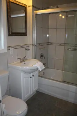 a bathroom with a sink and a shower and a toilet at The Classic Horseshoe Bay Motel in Horseshoe Bay