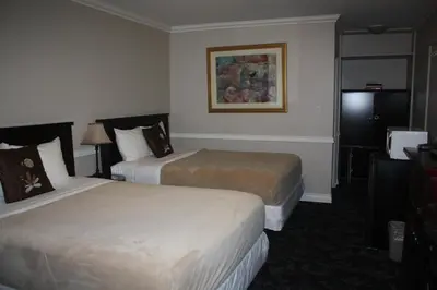 a hotel room with two beds and a television at The Classic Horseshoe Bay Motel in Horseshoe Bay