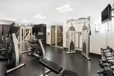 a gym with treadmills and machines in a room at Ramada Plaza by Wyndham Prince George in Prince George