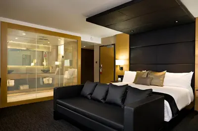 a hotel room with a bed and a couch at Ramada Plaza by Wyndham Prince George in Prince George