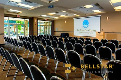 a conference room with chairs in front of a screen at The Beach Club Resort — Bellstar Hotels & Resorts in Parksville