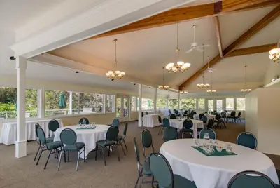 a banquet hall with white tables and chairs at South Thompson Inn & Conference Centre in Kamloops