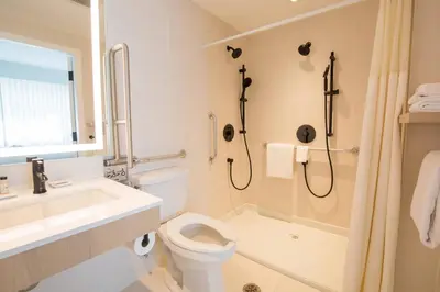 a bathroom with a toilet and a sink and a shower at Delta Hotels by Marriott Kamloops in Kamloops