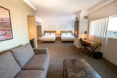 a living room with two beds and a couch at Delta Hotels by Marriott Kamloops in Kamloops