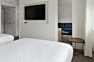 a bedroom with a bed and a tv on a wall at Delta Hotels by Marriott Kamloops in Kamloops