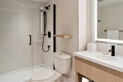 a bathroom with a toilet and a sink and a shower at Delta Hotels by Marriott Kamloops in Kamloops
