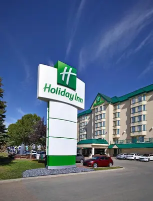 a hotel sign in front of a building at Holiday Inn Conference Centre Edmonton South by IHG in Edmonton