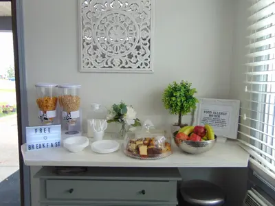 a table with a bowl of fruit and other items on it at Chateau Motel in Edmonton