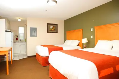a hotel room with two beds and a kitchen at Chateau Motel in Edmonton
