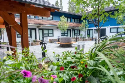 a garden with flowers in front of a building at The Dorothy Motel in Banff
