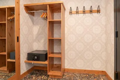 a room with wooden shelves and a wall with a wallpaper at The Dorothy Motel in Banff