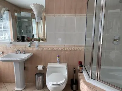 a bathroom with a toilet and a sink and a shower at Ocean Breeze Executive Bed and Breakfast in North Vancouver