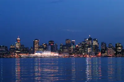 a view of a city at night from the water at Ocean Breeze Executive Bed and Breakfast in North Vancouver