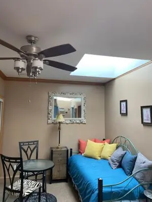 a bedroom with a ceiling fan and a bed at Ocean Breeze Executive Bed and Breakfast in North Vancouver