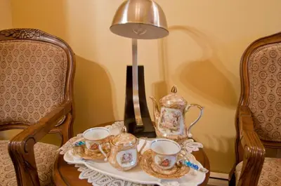a table with two chairs and a tea set on it at Ocean Breeze Executive Bed and Breakfast in North Vancouver