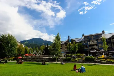 a group of people sitting on the grass in a park at Tyndall Stone Lodge by Whiski Jack in Whistler