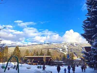 a group of people in the snow at a ski slope at Tyndall Stone Lodge by Whiski Jack in Whistler