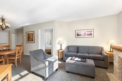 a living room with a couch and a table at Tyndall Stone Lodge by Whiski Jack in Whistler