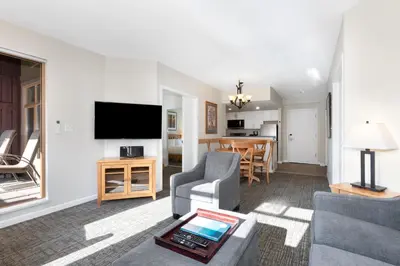 a living room with a couch and a tv at Tyndall Stone Lodge by Whiski Jack in Whistler