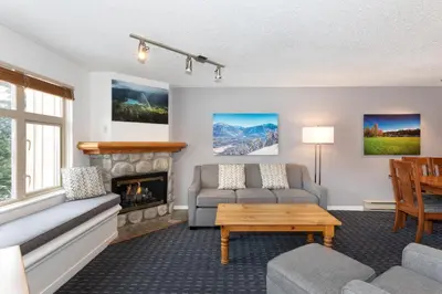 a living room with a couch and a fireplace at Lake Placid Lodge by Whiski Jack in Whistler