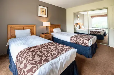 a hotel room with two beds and a window at The Ironwood on Blueberry Hill in Whistler