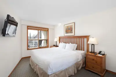 a hotel room with a bed and a television at The Aspens by Whiski Jack in Whistler