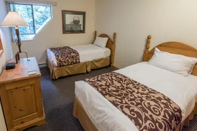 a hotel room with two beds and a window at Valhalla Vacations at Whistler in Whistler