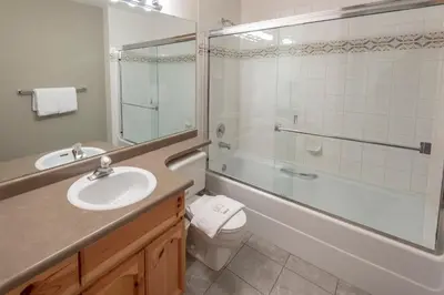 a bathroom with a sink and a tub and a toilet at Valhalla Vacations at Whistler in Whistler
