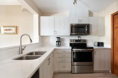 a kitchen with a sink and a stove at Northstar at Stoney Creek by Whiski Jack in Whistler