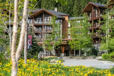 a large building with flowers in front of it at Evolution Whistler, by Lodging Ovations in Whistler