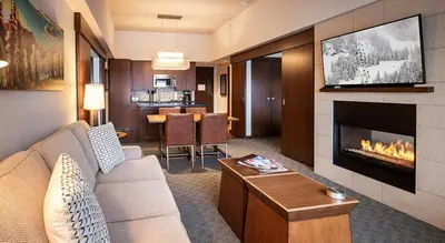 a living room with a couch and a fireplace at Evolution Whistler, by Lodging Ovations in Whistler