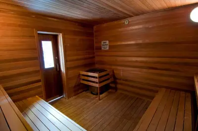 an empty room of a wooden cabin with a stove in it at Evolution Whistler, by Lodging Ovations in Whistler