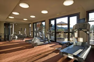 a gym with several treadmills and elliptical machines at Evolution Whistler, by Lodging Ovations in Whistler